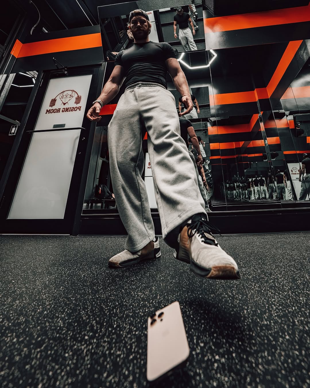 Mitchell in a black and orange posing room