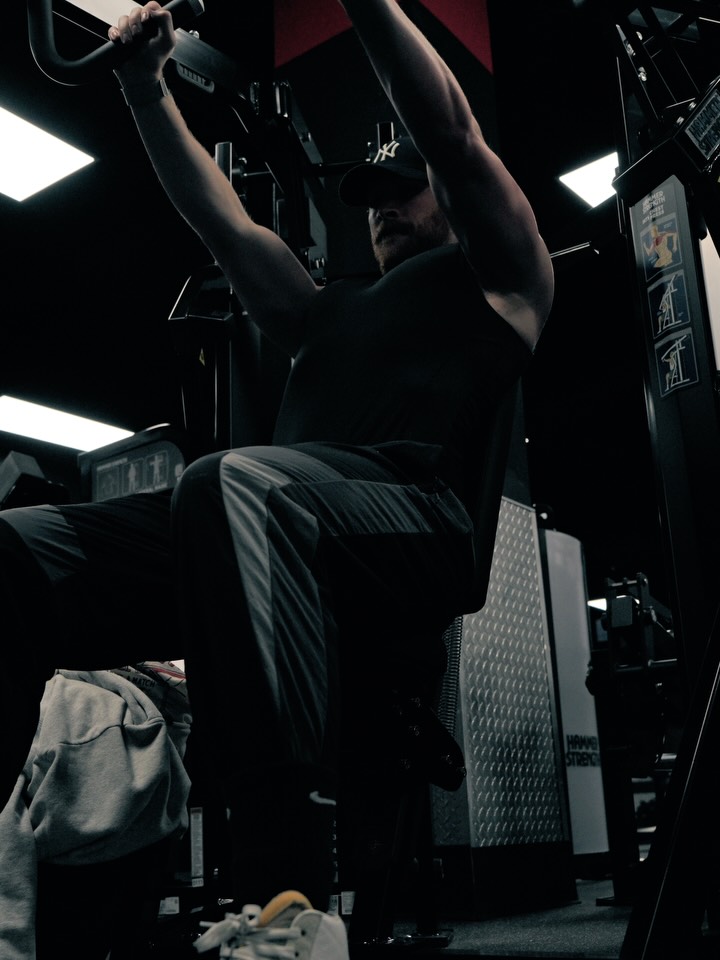 Lat pulldowns in a dark gym